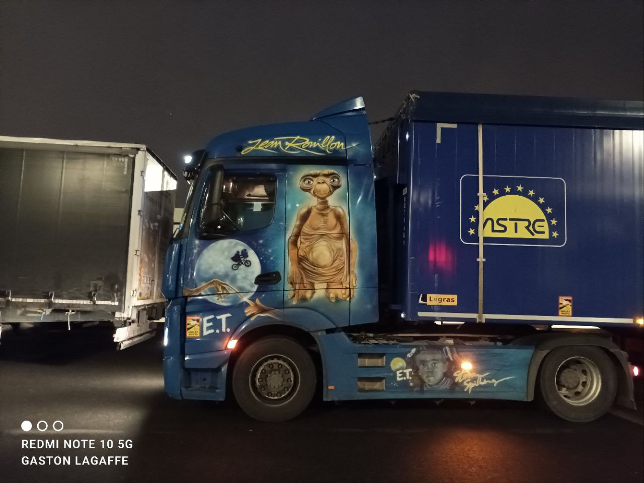 a blue truck with a painting on the side